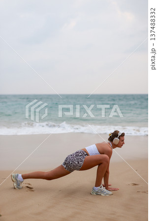 Runner On Beach. Dedicated Athlete Practices Endurance By Jogging Solitary Along Tranquil Ocean Coast 137488332