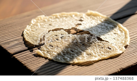 Wabi-sabi aesthetic. a delicate, translucent sheet of dried cheese paper (like usuba) that has cracked imperfectly, revealing a fragile, lace-like structure Wabi-sabi aesthetic. a delicate, translucent sheet of dried cheese paper (like usuba) that has cracked imperfectly, revealing a fragile, lace-like structure 137488368