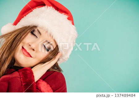 Woman in santa hat being sleepy Woman in santa hat being sleepy 137489484