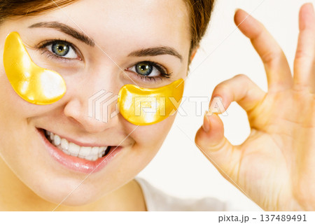 Woman with gold patches under eyes 137489491