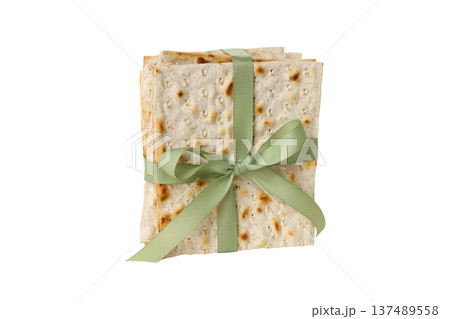 Matzah for Passover is tied with a green ribbon, isolated, PNG 137489558