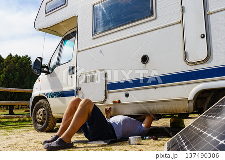 Man repairing bottom of the rv caravan Man repairing bottom of the rv caravan 137490306