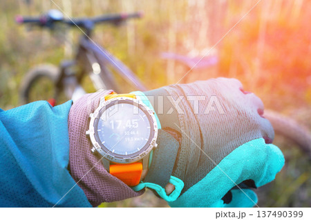 Smartwatch for mountain biking trails. Cyclist with GPS sports watch. Sport Watch for rider. Smartwatch for mountain biking trails. Cyclist with GPS sports watch. Sport Watch for rider. 137490399