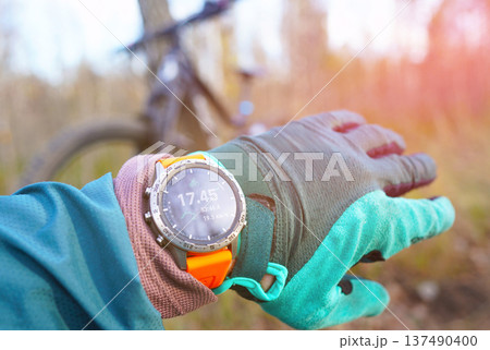 Smartwatch for mountain biking trails. Cyclist with GPS sports watch. Sport Watch for rider. Smartwatch for mountain biking trails. Cyclist with GPS sports watch. Sport Watch for rider. 137490400