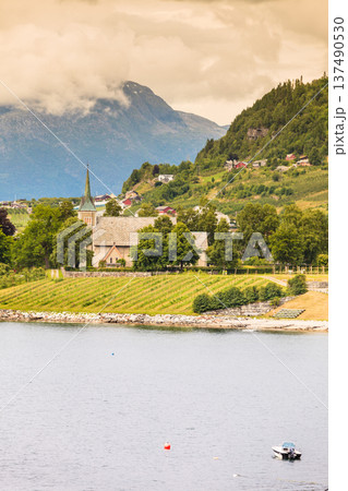 Mountains and fjord with village Norway. 137490530