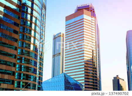 Skyscrapers in bright glass exteriors sunlight on sunset. Modern facade office buildings 137490702