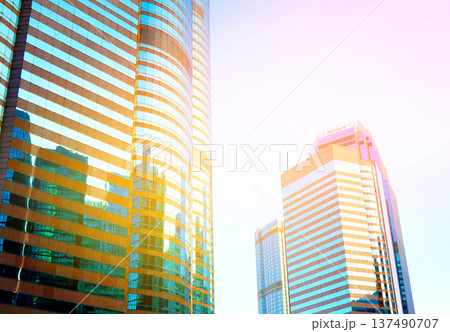 Skyscrapers in bright glass exteriors sunlight on sunset. Modern facade office buildings 137490707