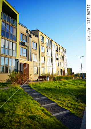 Steps stairs on pedestrian path to entrance of residential building. Eco-friendly condominium Steps stairs on pedestrian path to entrance of residential building. Eco-friendly condominium 137490737