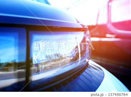 Headlight. LED headlamp of a modern car. Frontal lighting of highway vehicles Headlight. LED headlamp of a modern car. Frontal lighting of highway vehicles 137490764