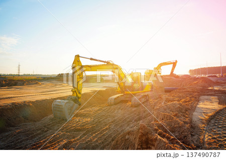 Excavator earthworks on construction site. Sewer line repair. Excavator groundwork water line repair Excavator earthworks on construction site. Sewer line repair. Excavator groundwork water line repair 137490787