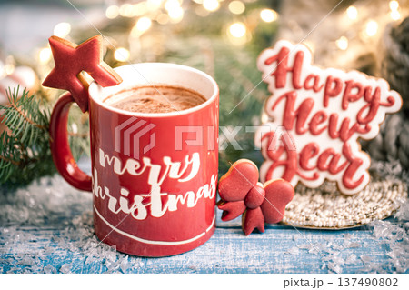 Christmas red cup with the inscription Merry Christmas on a blurred background with lights close up. 137490802