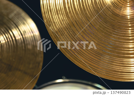 Drum cymbal close-up on a dark background. 137490823
