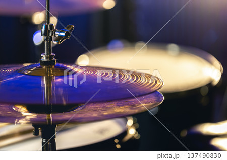 Drum cymbal close-up on a dark blurred background. 137490830