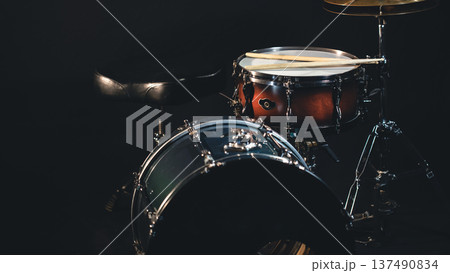 Drums on a dark background, part of a drum kit. 137490834