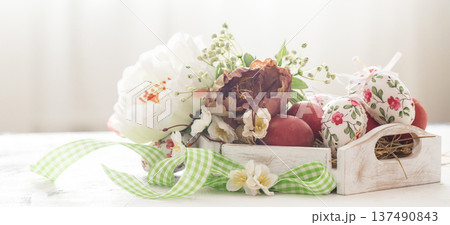 Easter background with a basket and red eggs with flowers 137490843