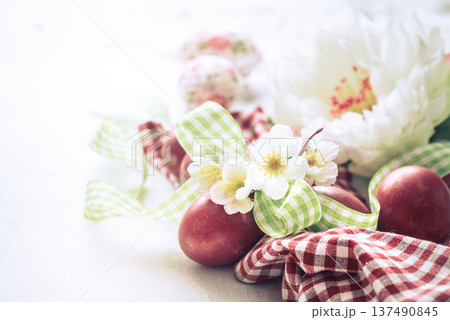 Easter background with a basket and red eggs with flowers 137490845