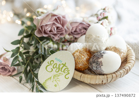 Easter composition with decorative eggs and flowers, close-up. Easter composition with decorative eggs and flowers, close-up. 137490872