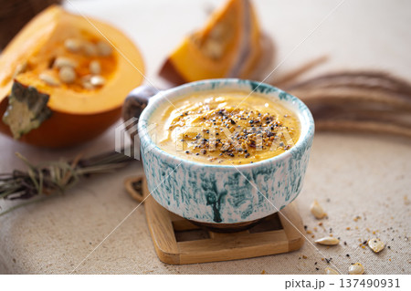 Appetizing composition with pumpkin soup close up. Appetizing composition with pumpkin soup close up. 137490931