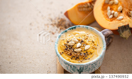 Close up shot of pumpkin soup in ceramic bowl copy space. Close up shot of pumpkin soup in ceramic bowl copy space. 137490932