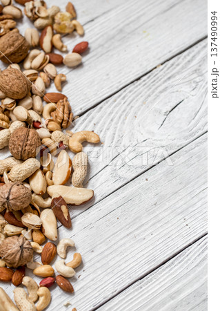 different nuts on white wooden background , 137490994