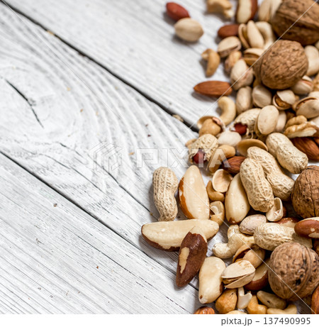 different nuts on white wooden background , 137490995