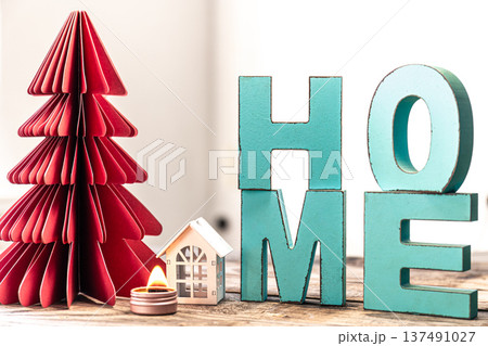 Cozy winter composition with decorative word home and paper christmas tree. 137491027