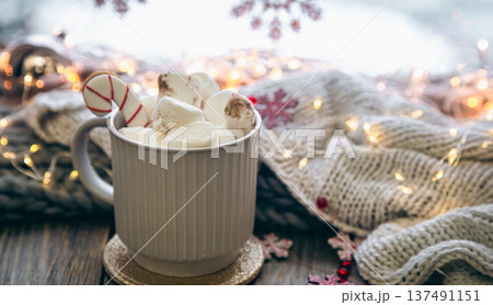 A cup of cocoa with marshmallows close-up on a blurred background. A cup of cocoa with marshmallows close-up on a blurred background. 137491151