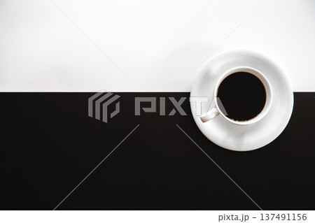 Cup of coffee on a black and white background, flat lay. Cup of coffee on a black and white background, flat lay. 137491156