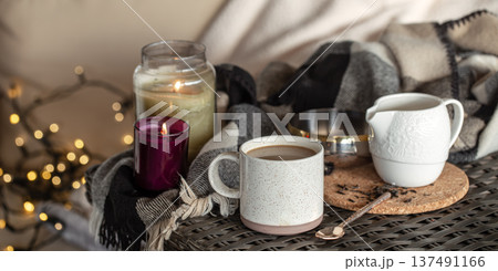 Cozy home composition with a cup of coffee and candles. 137491166