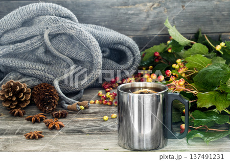 the Cup of tea on a beautiful wooden background with winter sweater, berries, autumn 137491231