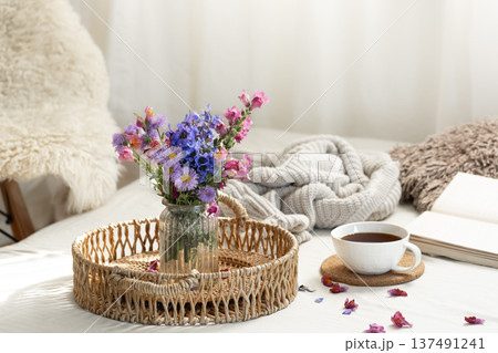 Cup of tea, a bouquet of wildflowers, book and knitted element. Cup of tea, a bouquet of wildflowers, book and knitted element. 137491241