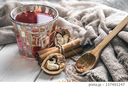 Cup of tea, cinnamon sticks and walnuts close-up. Cup of tea, cinnamon sticks and walnuts close-up. 137491247