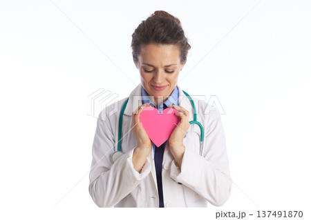 Thoughtful Doctor Looking at Heart Symbol 137491870