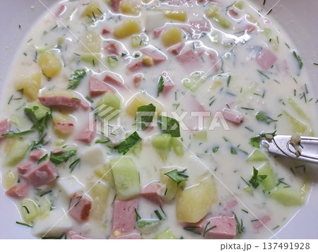 Close-up of traditional Russian cold soup okroshka with kefir, cucumbers, sausage, potatoes, and fresh parsley Close-up of traditional Russian cold soup okroshka with kefir, cucumbers, sausage, potatoes, and fresh parsley 137491928