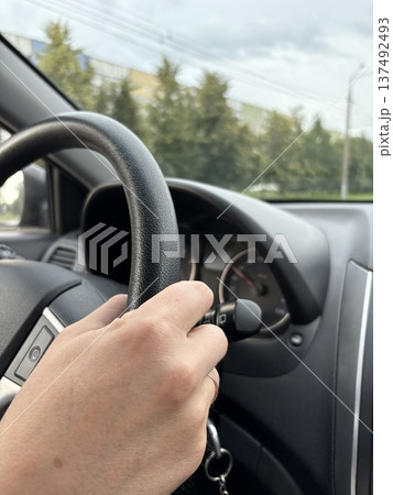 close-up of a male driver's hand on the steering wheel of a car close-up of a male driver's hand on the steering wheel of a car 137492493