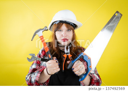 Young person holding construction tools ready for work Young person holding construction tools ready for work 137492569