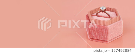 Banner with copy space. Luxury diamond ring in a pink gift box Banner with copy space. Luxury diamond ring in a pink gift box 137492884