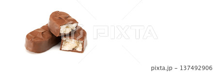Banner with copy space. A chocolate bar with a white filling is cut in half 137492906