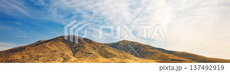 Banner with copy space. A mountain range with a valley in between Banner with copy space. A mountain range with a valley in between 137492919