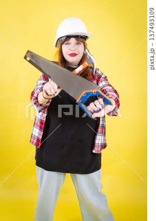Young woman holding construction tools ready for work Young woman holding construction tools ready for work 137493109