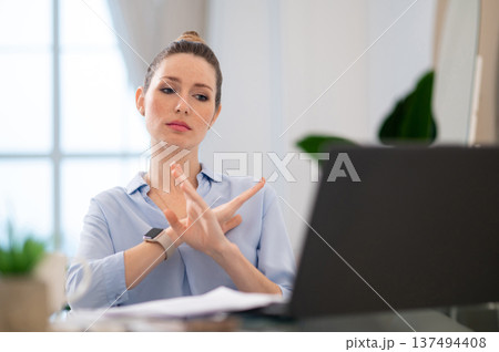 Young business woman finishing the video call with close gesture 137494408