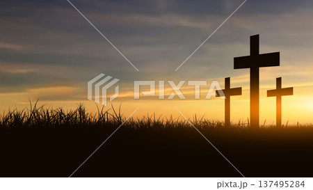 A silhouette of a Christian cross stands on a grassy hill under a dramatic sky with glowing sunset light breaking through the clouds. A symbol of faith, hope, and spirituality A silhouette of a Christian cross stands on a grassy hill under a dramatic sky with glowing sunset light breaking through the clouds. A symbol of faith, hope, and spirituality 137495284