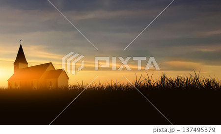 A silhouette of a church building stands peacefully against a dramatic sunset sky with a field of grass in the foreground. The golden and purple sky provides a beautiful and contemplative backdrop 137495379
