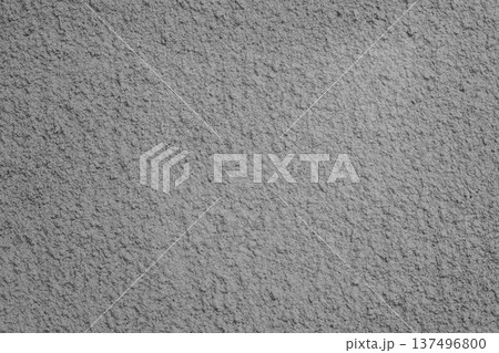 Textured gray plaster wall background with rough stucco finish and subtle shadow for design Textured gray plaster wall background with rough stucco finish and subtle shadow for design 137496800