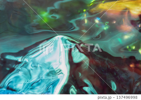 Abstract liquid colors swirl in vibrant turquoise, teal, and neon light reflections across the surface Abstract liquid colors swirl in vibrant turquoise, teal, and neon light reflections across the surface 137496998