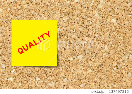 Yellow note paper with word quality on cork board background with copy space Yellow note paper with word quality on cork board background with copy space 137497816