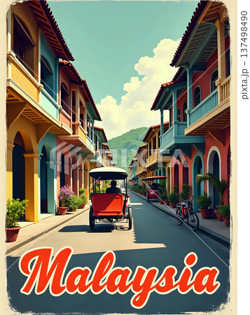 A rickshaw rides down a narrow street in Malaysia. Bright buildings line the road. Green hills are visible in the background under a clear blue sky. Plants decorate the scene. 137498490