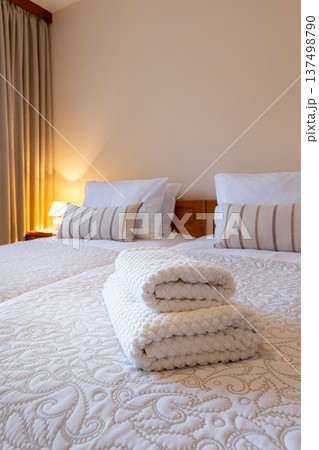 Clean hotel bedroom with white towels on beds 137498790
