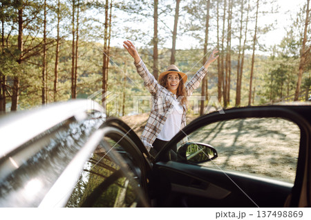 Young woman enjoying and having fun in their vacations outdoors leaning out car window. Summer trip. Young woman enjoying and having fun in their vacations outdoors leaning out car window. Summer trip. 137498869