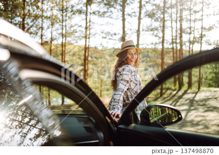 Young woman enjoying and having fun in their vacations outdoors leaning out car window. Summer trip. Young woman enjoying and having fun in their vacations outdoors leaning out car window. Summer trip. 137498870